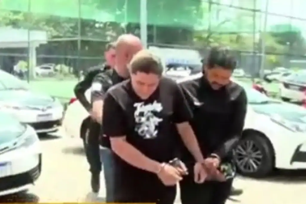 Captura de tela de Belão sendo escoltado após prisão em megaoperação policial